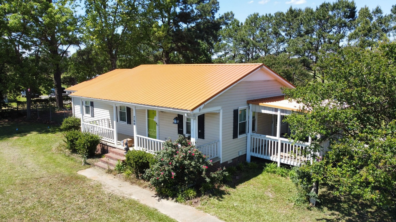 An orange metal roof was installed at 760 High House Rd, Clinton, NC by Gator Metal Roofing.