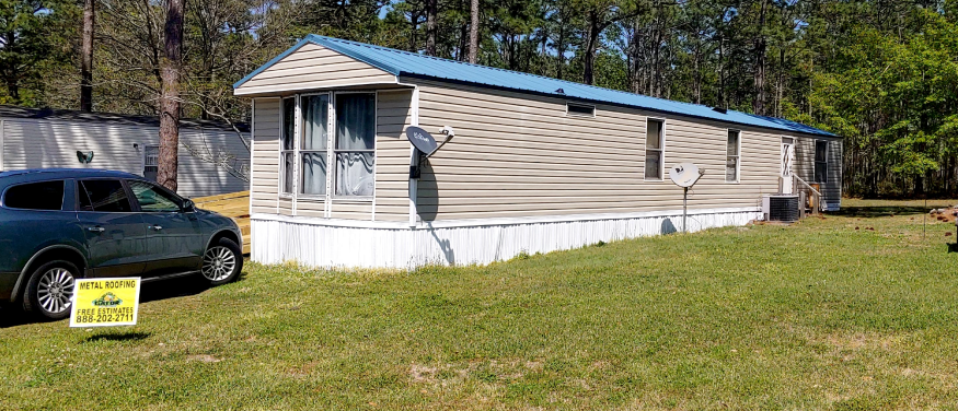 : A house with a blue metal roof shown during the day on 310 Spruce Pine Dr, Newport.