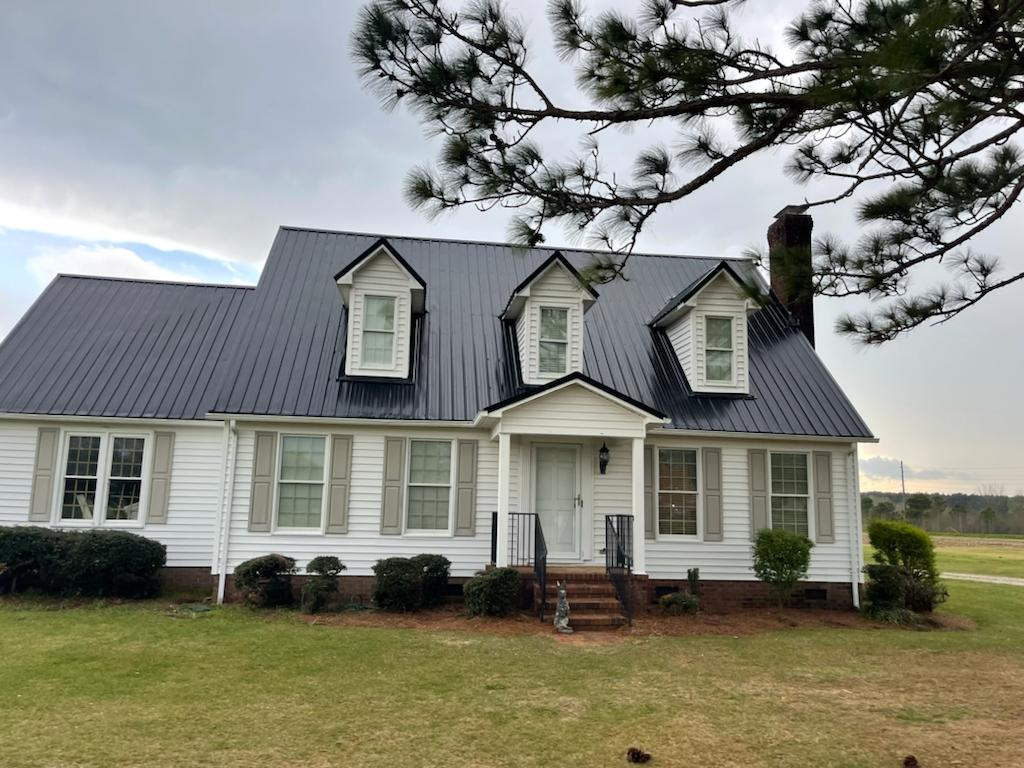 A brown metal roof was installed on a double-story house.